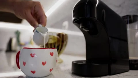 Puring milk in the coffee 動画素材 337221950