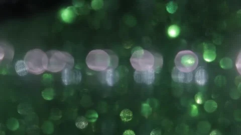Purple and green abstract bubble particles bokeh on black background Видео 317533669