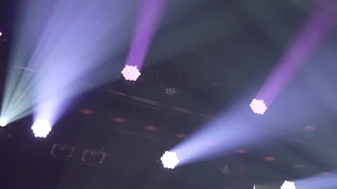 Purple and white stage lights emitting dynamic beams through smoke Stock Footage 346357238