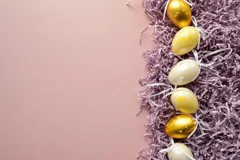 Purple background with golden Easter eggs Stock Photos