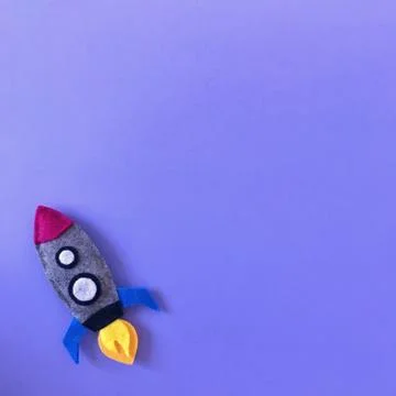 Purple Background with Handmade Felt Rocket Toy Stock Photos