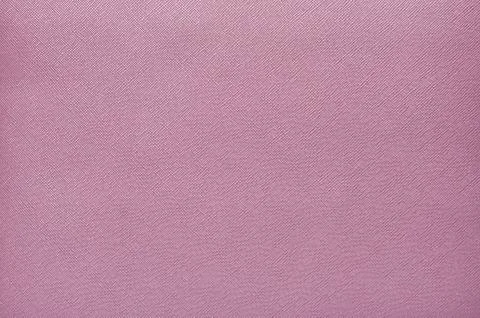 Purple background from a textile material with wicker pattern, closeup. Stock Photos