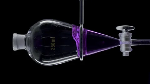 Purple basil hydrosol injected forming vibrant splash in funnel Stock Footage 340501016