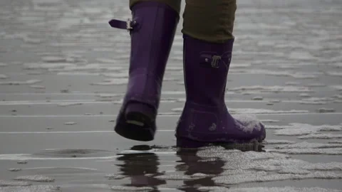 Purple boots in the surf Stock Footage 147165792