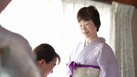 Purple bow tightened over a patterned obi Stock Footage 344015412