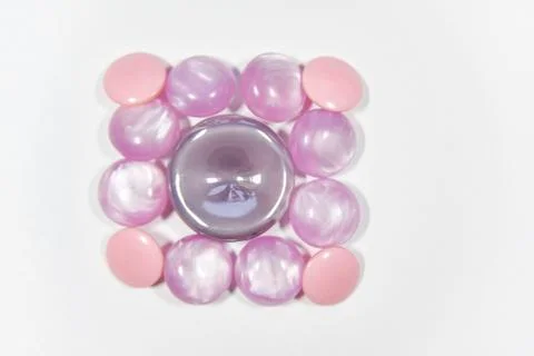 Purple buttons of different shape and size on the white background. Selective Stock Photos