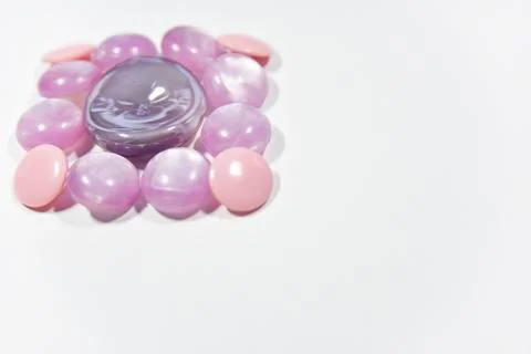 Purple buttons of different shape and size on the white background. Selective Stock Photos