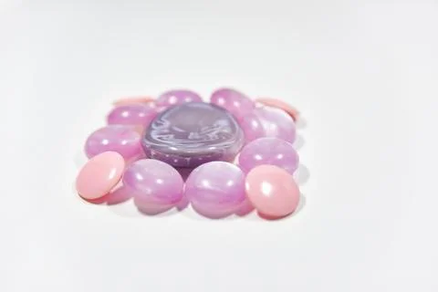 Purple buttons of different shape and size on the white background. Selective Stock Photos