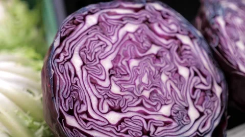 Purple cabbage are placed in a container at a market stall Stock Footage 186524402