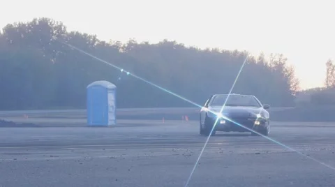 Purple car rounds corner on race track at dusk. Stock Footage 59762284