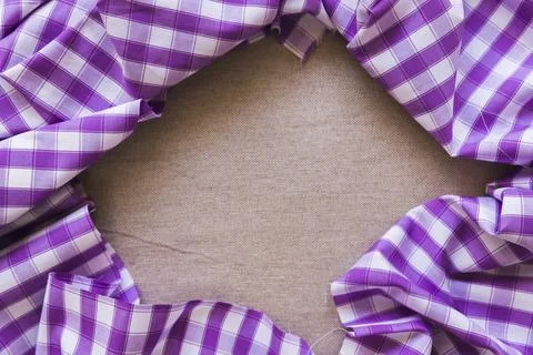 Purple chequered pattern textile forming frame Stock Photos
