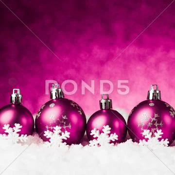 Purple christmas balls on snow Stock Photos