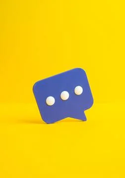 Purple comment clouds on a yellow background express opinions and feedback. R Stock Photos