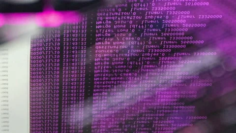 Purple computer software code moving on a black monitor reflect on glass. Abs 스톡 동영상 144047114