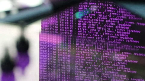 Purple computer software code moving on a black monitor reflect on glass. Abs 스톡 동영상 144047722