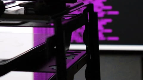 Purple computer software code moving on a black monitor reflect on glass. Abs Stock Footage 144049649