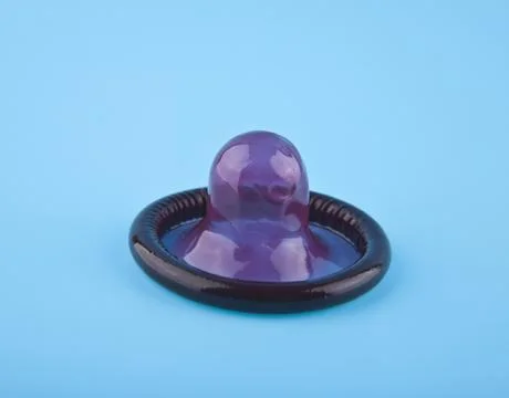 Purple condom Stock Photos