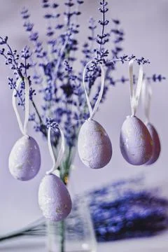 Purple Easter eggs hanging on lavender branches Foto stock