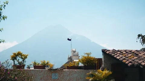 Purple easter flag on church with volcano Stock Footage 293107379