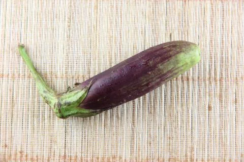 Purple eggplant on bamboo pattern background. Stock Photos