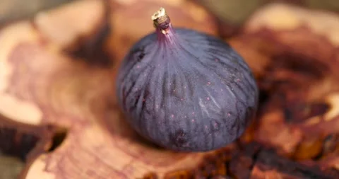 Purple fig on a juniper board, ripe fig fruit on the kitchen table before Stock Footage 305865739