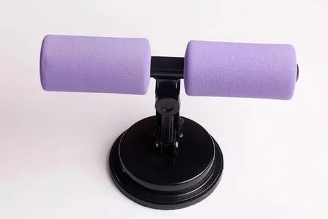 Purple foam roller on black base for exercise or therapy Fotos Stock