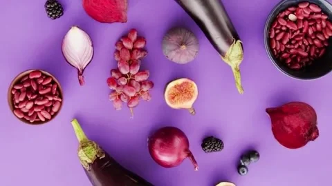 Purple food ingredients assorted on flat lay background cinematic video. Stock Footage 336332703