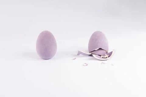 Purple Fuzzy Easter Eggs: One Intact, One Cracked Open, Revealing Creamy In.. Stock Photos