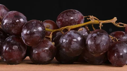 Purple grapes with black background, camera moves from right to left on a slider 動画素材 284566042