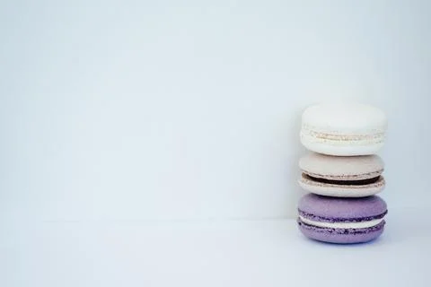 Purple gray and white macarons on a white background fresh and delicious dess Stock Photos