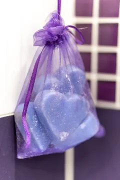 Purple heart-shaped objects in a purple transparent bag Foto stock