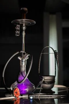 Purple hookah placed on a table Stock Photos