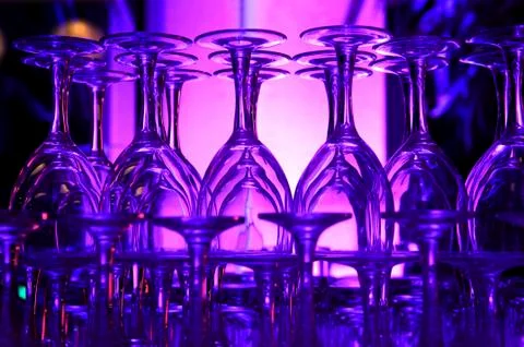 Purple hued stack of wine glasses Stock Photos