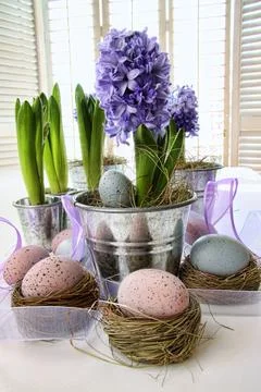 Purple hyacinths and easter eggs on table Stock Photos