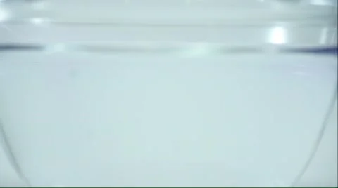 Purple ink dropping into clear water Stock Footage 50152853