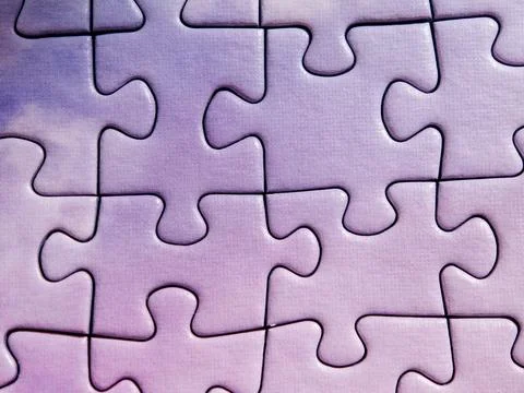 Purple jigsaw puzzle with last missing piece being placed into hole 스톡 사진