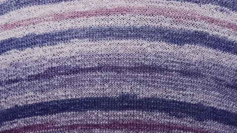 Purple knitted fabric texture macro tracking slowly across striped violet wool y Stock Footage 337025539