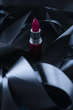 Purple lipstick on black silk background, luxury make-up and beauty cosmetic Stock Photos