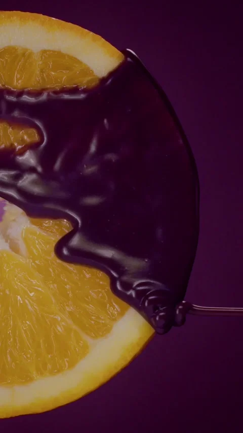 Purple liquid flows over an orange on a purple background 動画素材 237705635