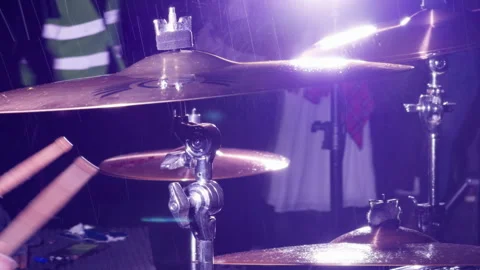Purple lit drum kit with blurred stick, glowing cymbals, and chrome hardware in Stock-Footage 344966114
