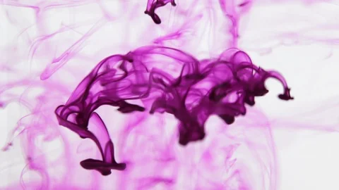 Purple - pink ink falling through water Stock Footage 118214077