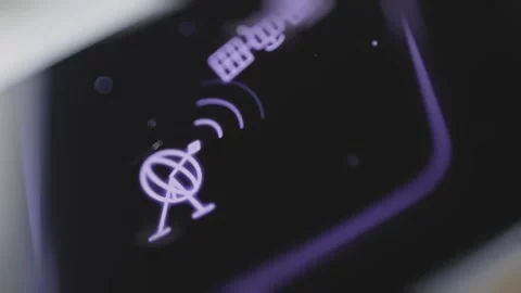 Purple satellite faces a ground dish with luminous communication waves Vídeo Stock 343379343