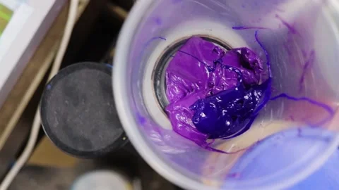 Purple screen printing ink paint in cup. top-down view Stock Footage 139387450