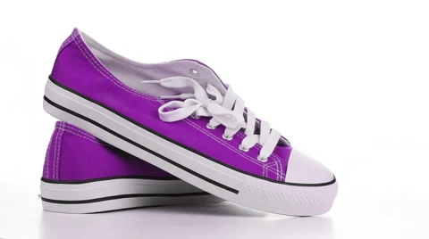 Purple sneakers revolve on a white background Stock Footage 50528302