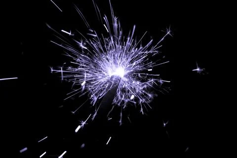 Purple sparkler countdown on fire with spread of glitter sparks. Luxury enter Stock Photos