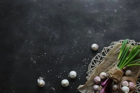 Purple spring onions on dark table background Stock Photos