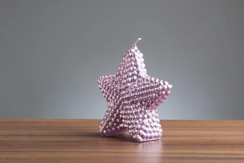 Purple star shape candle on table Stock Photos