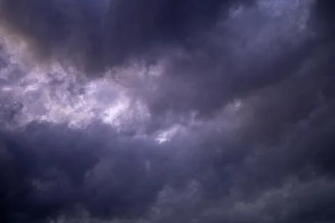 Purple storm clouds in dramatic evening sky Stock Photos