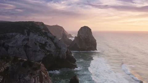 Purple sunset clouds over the westernmost European beach with dominating rocks Stockbeeldmateriaal 162291646