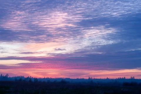 Purple Sunset Over Fields Stock Photos
